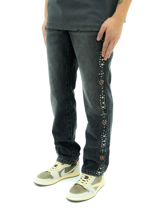 Black jeans with colorful embellishments on leg.